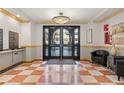 Inviting building lobby with tiled floors, neutral color scheme and secured entry at 150 S Madison St # 303, Denver, CO 80209