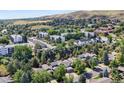 A beautiful aerial view of this neighborhood with mature trees and mountain views at 14562 W 3Rd Ave, Golden, CO 80401