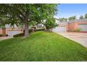 Beautiful exterior featuring mature trees, green grass and a well manicured lawn at 14562 W 3Rd Ave, Golden, CO 80401