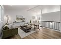 Bright living room with modern furniture and hardwood floors at 16930 E Wagontrail Pkwy, Aurora, CO 80015