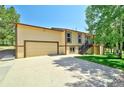 Exterior view featuring a two-car garage, concrete driveway, and well-maintained lawn at 19235 Wakonda Way, Monument, CO 80132