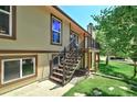 Exterior showcasing a staircase leading to a deck, with lovely landscaping and yard at 19235 Wakonda Way, Monument, CO 80132