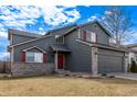 Beautiful two-story home with gray siding, red shutters, and a well-manicured lawn at 4630 E 135Th Way, Thornton, CO 80241