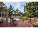 Spacious deck with rocking chairs offering scenic mountain views at 9189 Fallen Rock Rd, Conifer, CO 80433