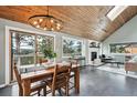 Open concept dining area with a wood table and mountain views at 9189 Fallen Rock Rd, Conifer, CO 80433