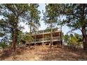 Two-story home nestled in a wooded area with expansive decks at 9189 Fallen Rock Rd, Conifer, CO 80433