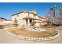 Two-story house with a landscaped front yard and white picket fence at 19805 E 58Th Pl, Aurora, CO 80019