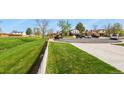 Residential street showcasing well-maintained lawns and mature trees in a peaceful neighborhood setting at 4510 E 121St Pl, Thornton, CO 80241