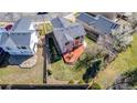 Aerial view of the home's backyard featuring a spacious lawn and wooden deck at 5171 E 119Th Ct, Thornton, CO 80233