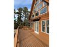 A large wrap-around deck with wood railing and mountain views at 4924 S Indian Trail, Evergreen, CO 80439