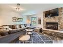 Inviting living room with a stone fireplace, plush sofa, and a window showcasing nature at 815 Columbine Rd # 22, Breckenridge, CO 80424