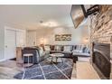 Comfortable living room featuring a stone fireplace, large sectional sofa, and modern decor at 815 Columbine Rd # 22, Breckenridge, CO 80424