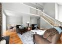 Spacious living room with hardwood floors, stairs to an upper level, and dining area at 6401 S Forest St, Centennial, CO 80121