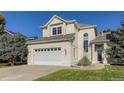 Beige two-story house with a two car garage and manicured lawn at 370 Terra Vista St, Brighton, CO 80601