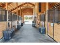 Beautiful equestrian barn with stalls and tack storage creating a functional workspace at 9250 Steeplechase Dr, Franktown, CO 80116