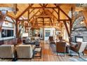 Spacious living room with high ceilings and a stone fireplace at 9250 Steeplechase Dr, Franktown, CO 80116