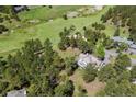 Expansive aerial view shows the home nestled amongst lush greenery and mature trees in the community at 2122 Cramner Ct, Evergreen, CO 80439