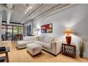 This light-filled living room offers a spacious seating area, modern lighting, and beautiful bamboo floors at 1401 Wewatta St # 202, Denver, CO 80202