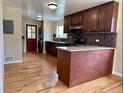 Spacious kitchen featuring hardwood floors, granite countertops, and stainless steel appliances at 1801 S Grove St, Denver, CO 80219