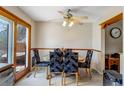 Cozy dining area with stylish upholstered chairs and a ceiling fan for added comfort at 9040 Raleigh St, Westminster, CO 80031