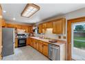 Traditional kitchen featuring wood cabinets, stainless steel appliances, and plenty of counter space at 9040 Raleigh St, Westminster, CO 80031