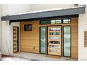 Inviting entryway with wood siding and modern door at 26467 Bell Park Dr, Evergreen, CO 80439