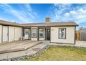 View of the home's front entrance and deck at 4360 E 70Th Ct, Commerce City, CO 80022