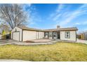 House exterior showcasing a deck and well-maintained lawn at 4360 E 70Th Ct, Commerce City, CO 80022