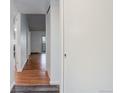 Hallway with hardwood floors leading to bedrooms and living spaces at 755 S Alton Way # 9D, Denver, CO 80247