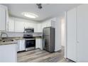 Bright kitchen featuring white cabinets, stainless steel appliances and modern flooring at 755 S Alton Way # 9D, Denver, CO 80247