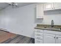 Corner kitchen view featuring white cabinets, granite countertops and stainless steel sink at 755 S Alton Way # 9D, Denver, CO 80247