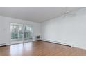 Spacious living room with hardwood floors and sliding glass doors to a private balcony at 755 S Alton Way # 9D, Denver, CO 80247