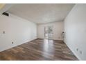 Simple living room with wood-style floors, a sliding door to a balcony, and natural light at 16259 W 10Th Ave # A4, Golden, CO 80401