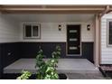Inviting covered front porch with modern black accent door and updated light fixtures at 1772 Eisenhower, Louisville, CO 80027