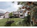 Well-maintained home with a green lawn and young trees enhancing its curb appeal at 1772 Eisenhower, Louisville, CO 80027