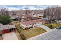 Aerial view of a single story home with a two car garage in a suburban neighborhood at 12020 W Center Ave, Lakewood, CO 80228