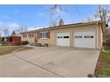 Single-story house with brick exterior, a two-car garage, and a spacious driveway at 12020 W Center Ave, Lakewood, CO 80228