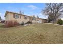 Charming single-story home with a large front yard and attached two-car garage at 12020 W Center Ave, Lakewood, CO 80228