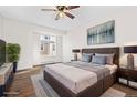 Spacious bedroom boasts a large bed, wood floors, contemporary decor, and a window with a view at 4062 S Atchison Way # 302, Aurora, CO 80014