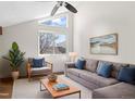 Inviting living room showcases vaulted ceilings, modern decor, a plush sofa, and natural light at 4062 S Atchison Way # 302, Aurora, CO 80014