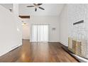 Spacious living room with hardwood floors, ceiling fan, and tall ceilings at 4062 S Atchison Way # 302, Aurora, CO 80014