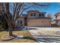 Charming two-story home with stone accents and attached two-car garage at 8493 S Newcombe Way, Littleton, CO 80127