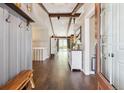 Spacious entryway with hardwood floors, wooden beams, and stylish decor creating a warm welcome at 8966 Sunridge Hollow Rd, Parker, CO 80134