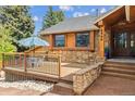Inviting home with a stone facade, a charming deck, and a beautifully landscaped entrance at 8966 Sunridge Hollow Rd, Parker, CO 80134