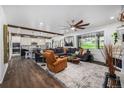 Open-concept living room with dark wood floors seamlessly connecting to the kitchen and dining area at 4555 Gray Wolf Ln, Castle Rock, CO 80104