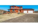 Exterior elevation showing large deck, solar panels, two-car garage, and circular driveway at 4586 Best Rd, Larkspur, CO 80118