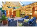 Relaxing backyard patio area with stylish seating, outdoor lighting, and lush greenery at 1497 S Fairfax St, Denver, CO 80222
