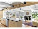 Bright open floor plan with kitchen island, dining area, and cozy living space at 1497 S Fairfax St, Denver, CO 80222