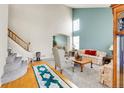 Inviting living room features a grand staircase, tall ceilings, and comfortable seating arrangement at 19939 E Belleview Ln, Centennial, CO 80015