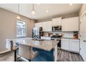Kitchen with granite countertops, stainless appliances and island with barstool seating at 4781 Rosette St, Castle Rock, CO 80104
